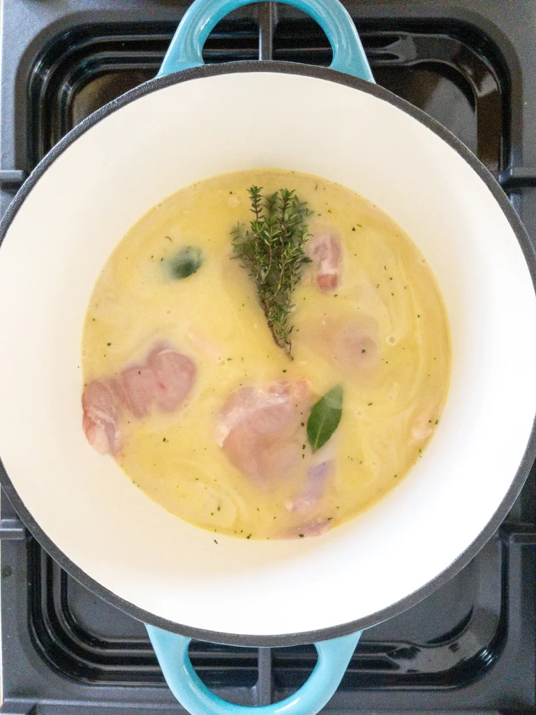 Poaching chicken in dairy free milk and stock for the dairy free chicken pot pie recipe