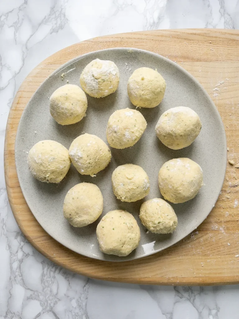 Finished rolled dumplings on a plate ready for cooking