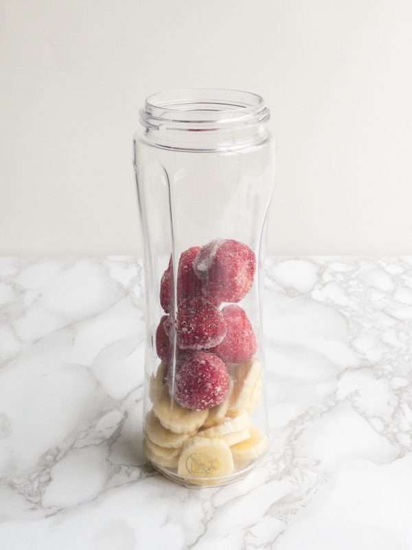 Strawberry and banana ready to blend in a blender jug