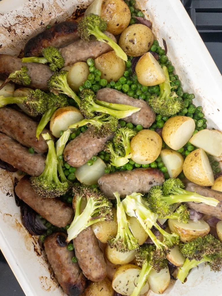 Easy dinner recipe with sausages, potatoes, red onion, broccoli and peas