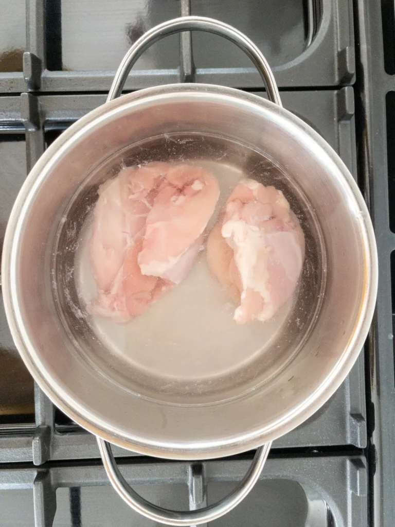 Poaching chicken for salad olivieh.