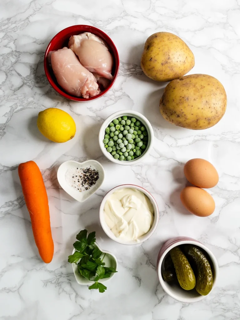 Ingredients for Olivieh Salad. Chicken, potato, egg, veggies, pickles and a dairy-free mayonnaise dressing.