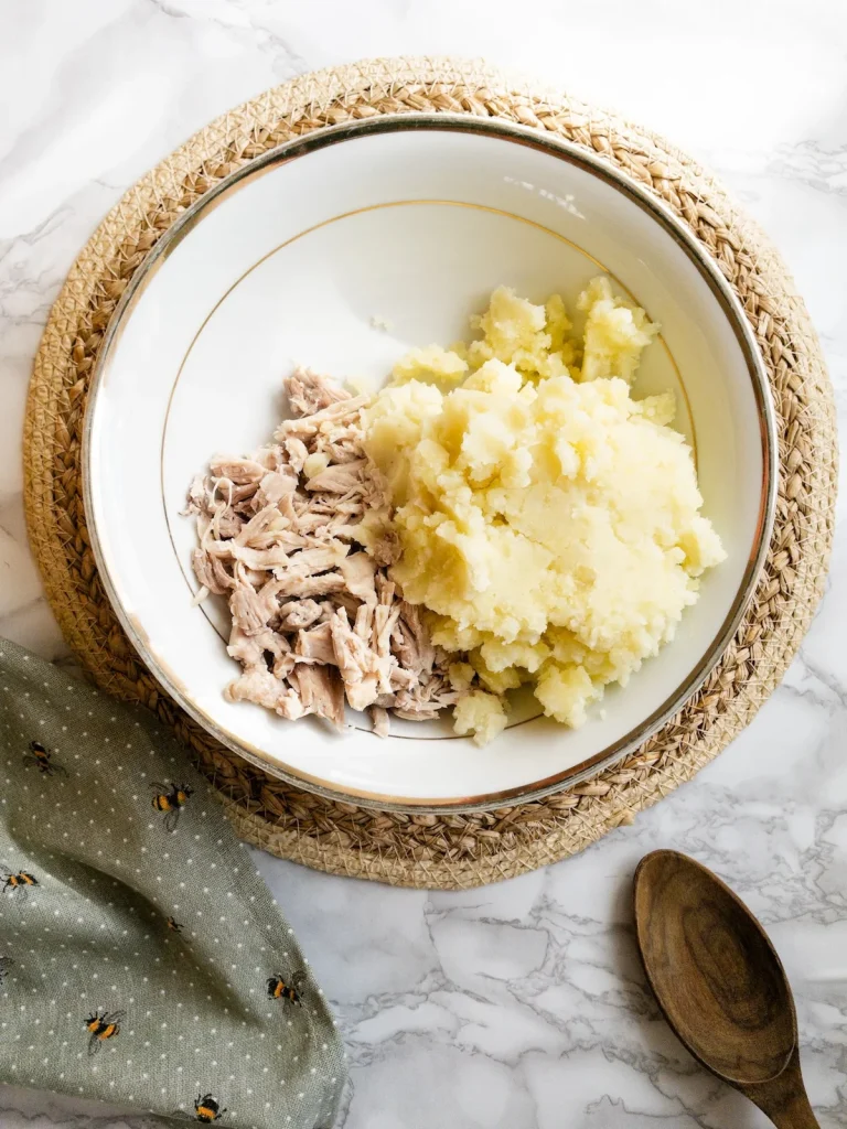 Add mashed potato to the chicken for Olivieh Salad.