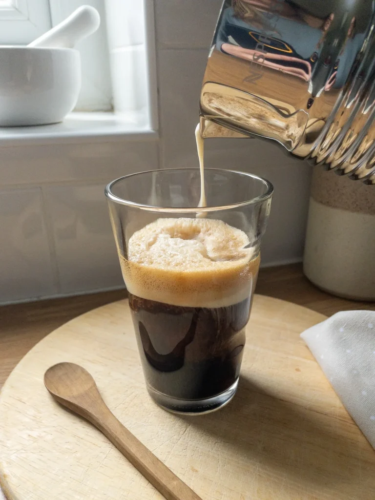 Starbucks copycat cold foam: pour foam onto coffee