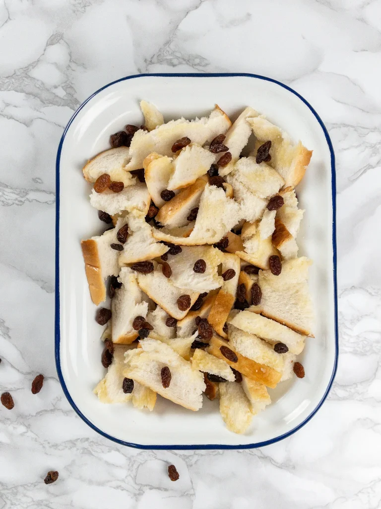 Bread cubes with melted butter and raisins for Bread Pudding