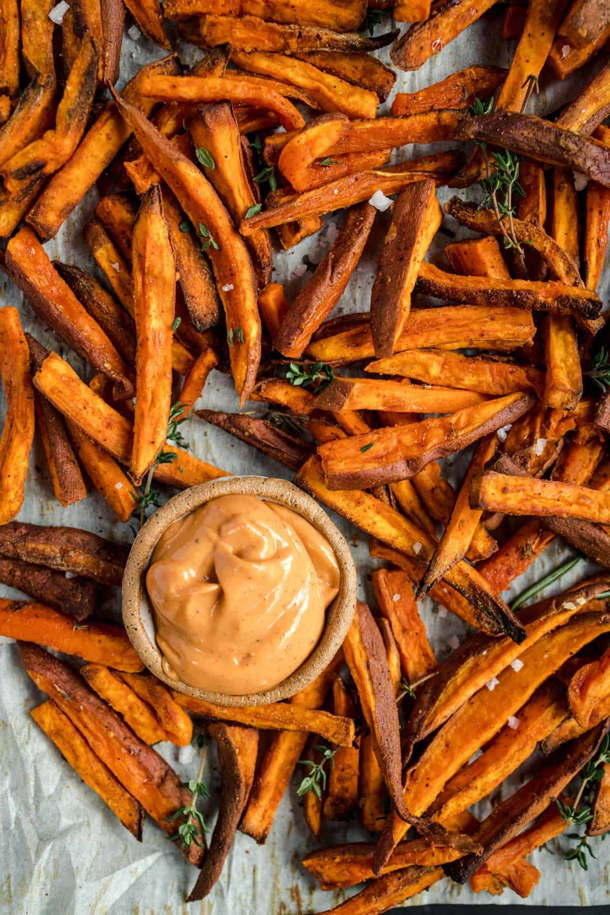 Oven roasted sweet potato fries recipe with a bowl of dipping sauce.