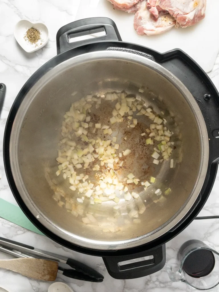 Sauteing onion in the Instant pot for the pork chop gravy.