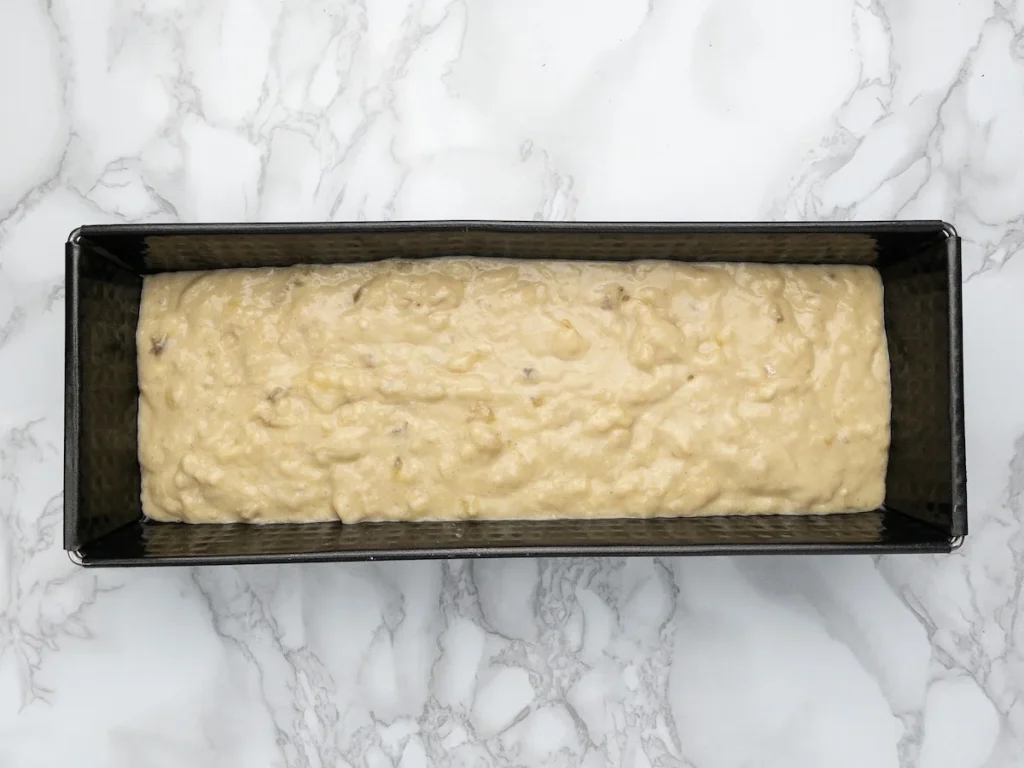 Dairy-free banana bread batter in a loaf pan.