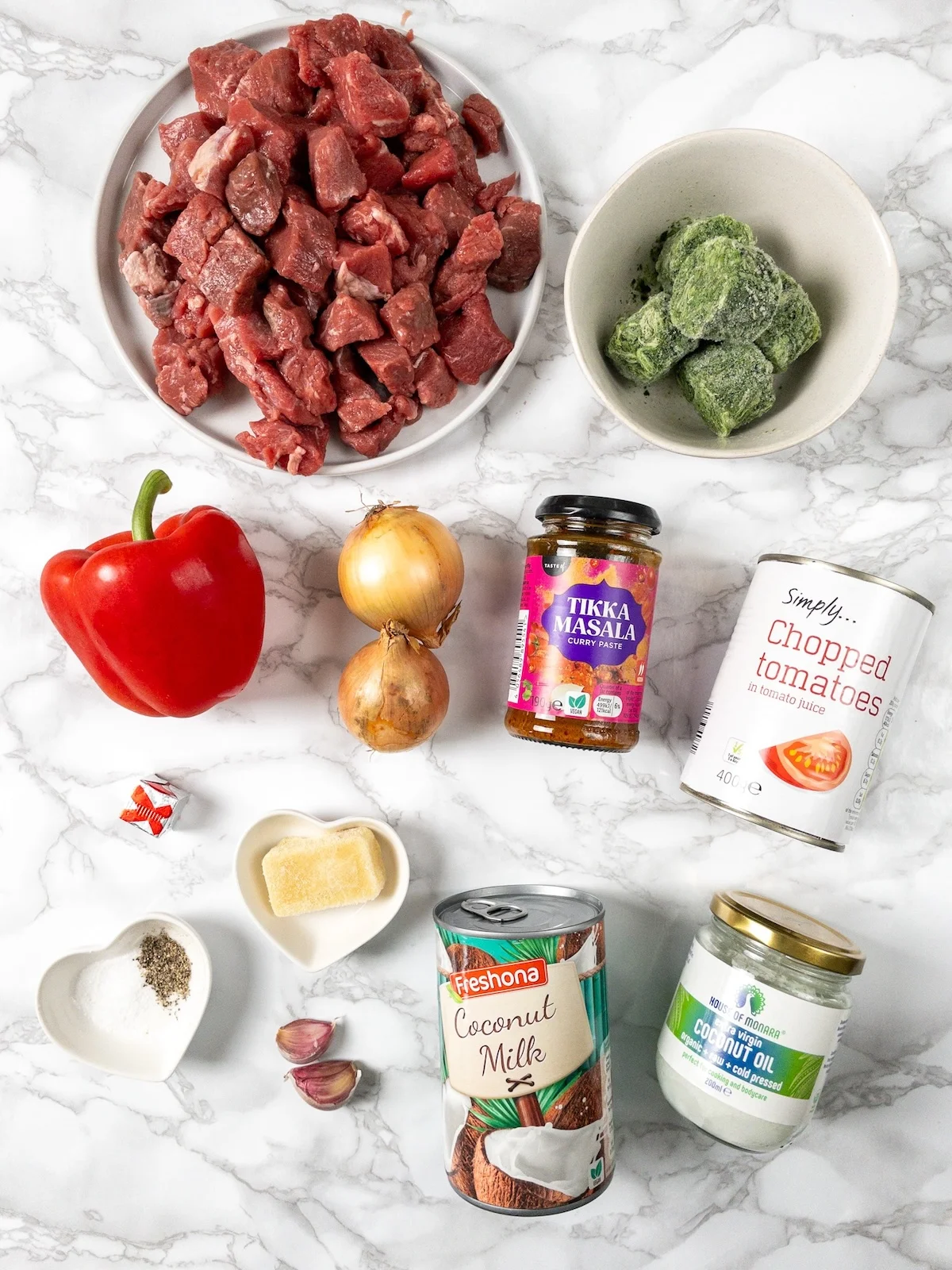 Ingredients for Instant Pot beef curry, including diced beef, curry paste, coconut milk and chopped tomatoes.