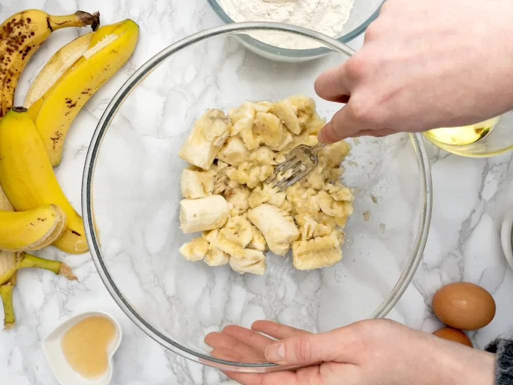 Mashing bananas for dairy-free banana bread.