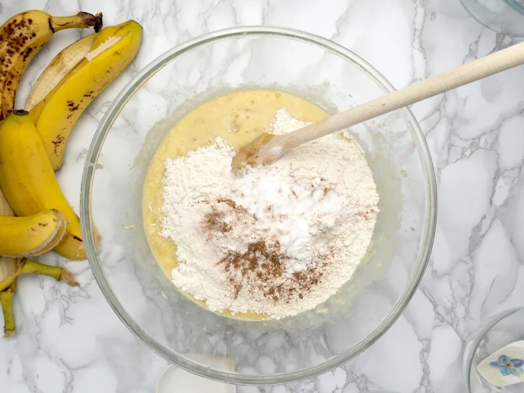 Mixing the dry ingredients into the batter.