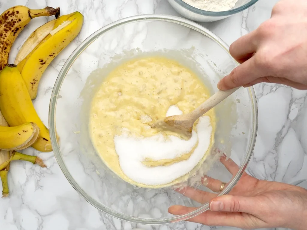 Adding the sugar to the wet ingredients.