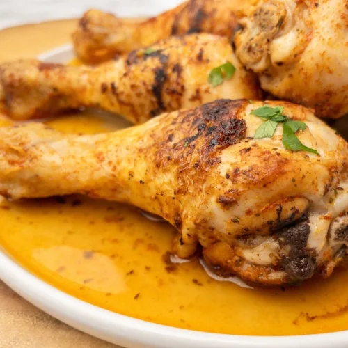 Close-up of pan fried chicken drumsticks