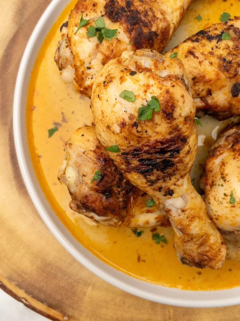 Skillet chicken drumsticks served on a plate.