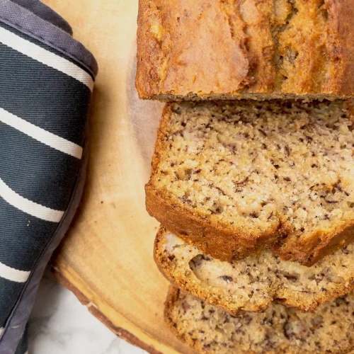 Sliced dairy-free banana bread on a board.