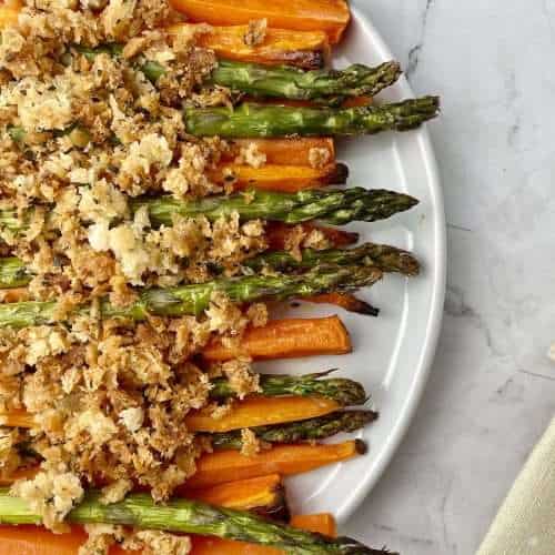 Roasted carrots and asparagus topped with golden breadcrumbs.