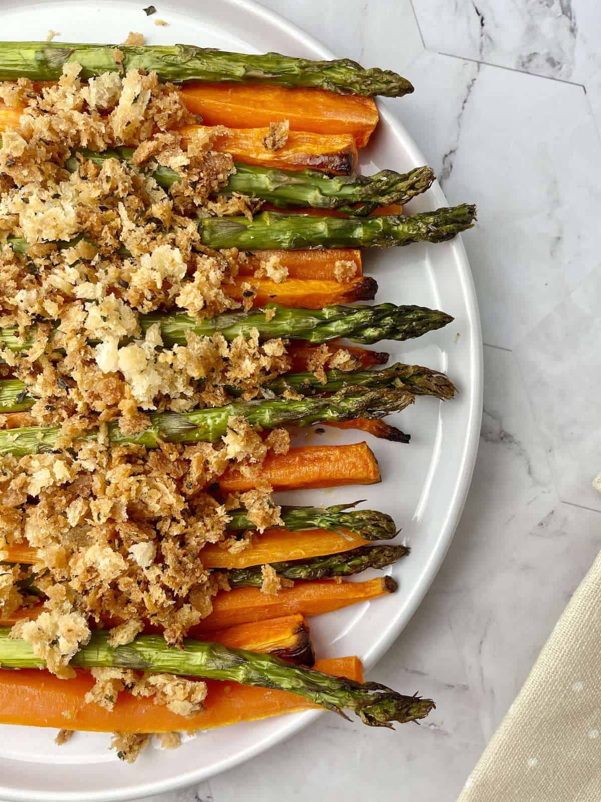 Roasted carrots and asparagus topped with golden breadcrumbs.