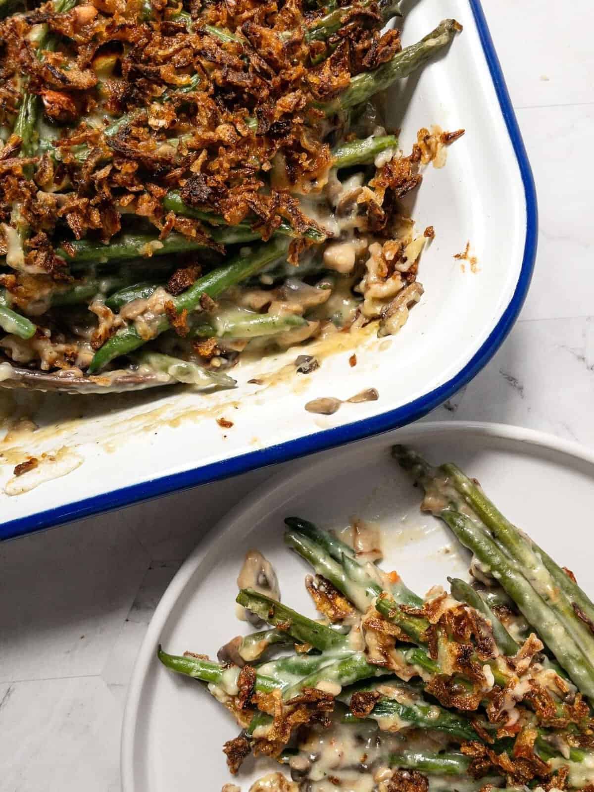 A dish and plate of holiday dairy-free green bean casserole.