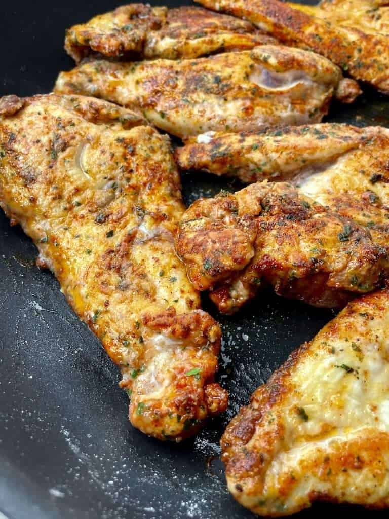 Browning Cajun chicken in a skillet