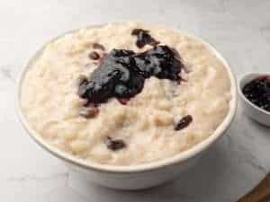 Close-up of dairy-free rice pudding with a dollop of jam on the top.